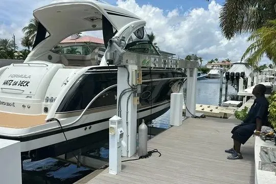 Slide: The Image of 2016 Formula 37 Performance Cruiser docked at marina with palm trees and blue sky. - 20