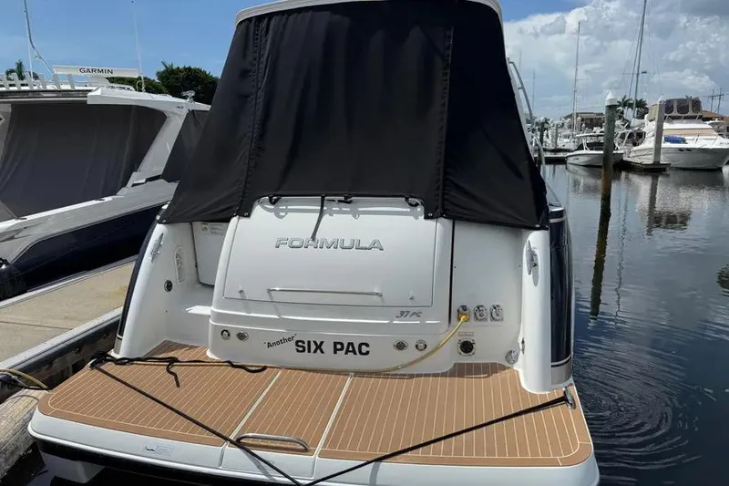Slide: The Image of 2016 Formula 37 Performance Cruiser docked at marina, rear view with black cover. - 21