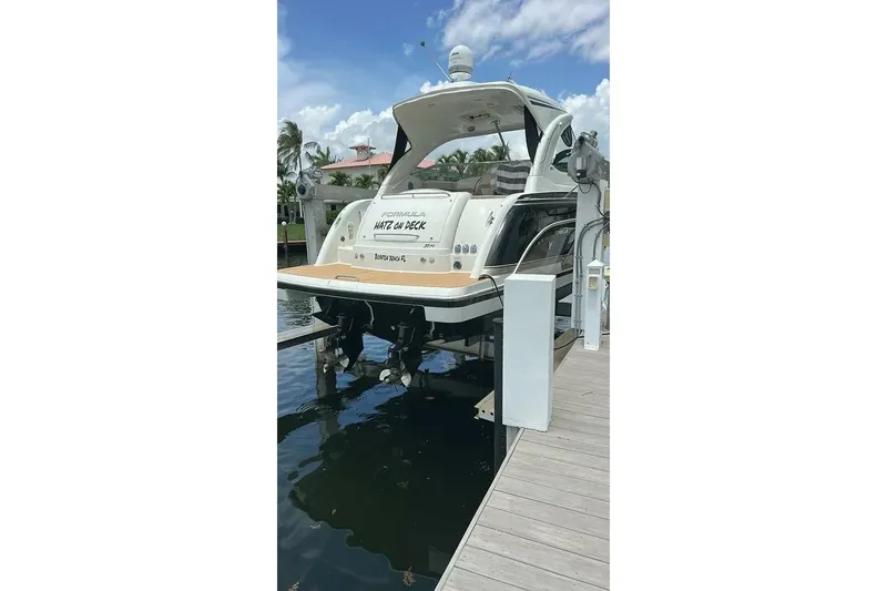 Slide: The Image of 2016 Formula 37 Performance Cruiser docked by the water under a clear sky. - 33