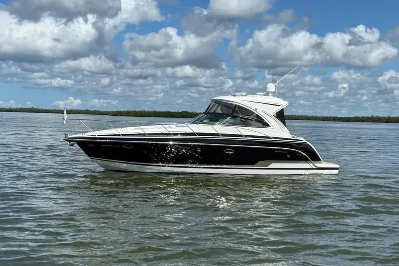 Slide: The Image of 2016 Formula 37 Performance Cruiser on calm water under a partly cloudy sky. - 37