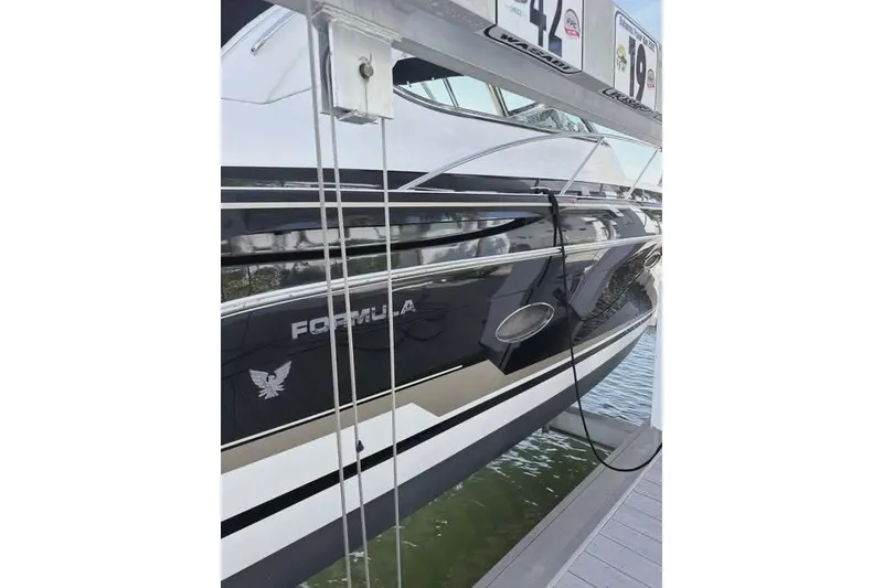 Slide: The Image of 2016 Formula 37 Performance Cruiser docked, showcasing sleek black and white design. - 41