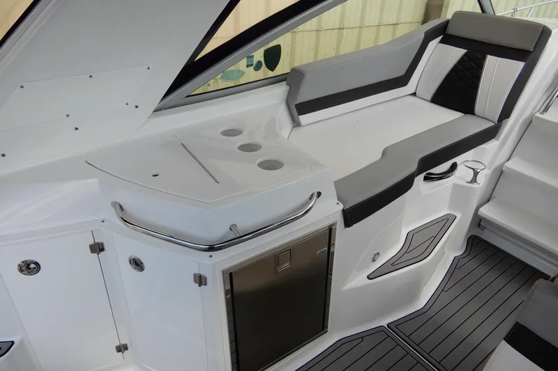 Slide: The Image of 2022 Monterey 295 Sport Yacht interior with sleek seating and modern amenities. - 16
