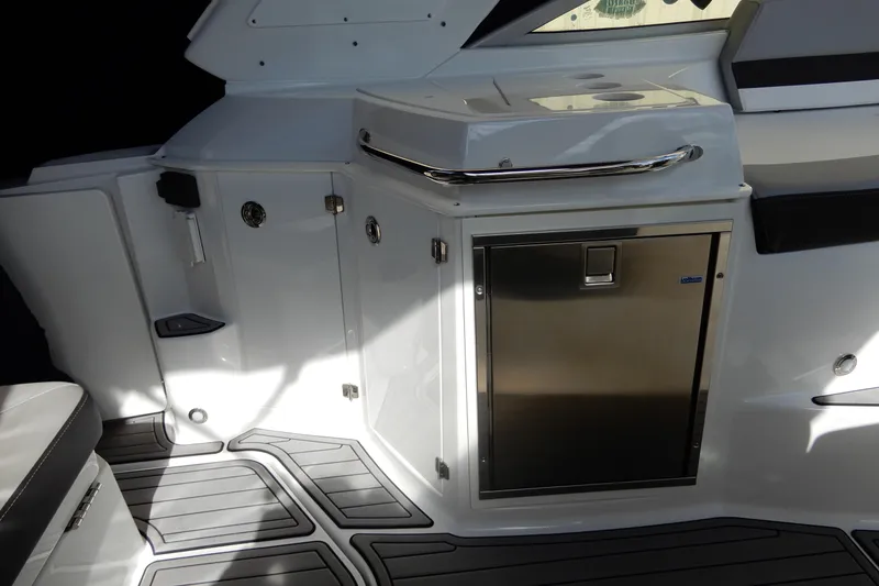 Slide: The Image of Interior view of 2022 Monterey 295 Sport Yacht featuring sleek cabinetry and stainless steel accents. - 18