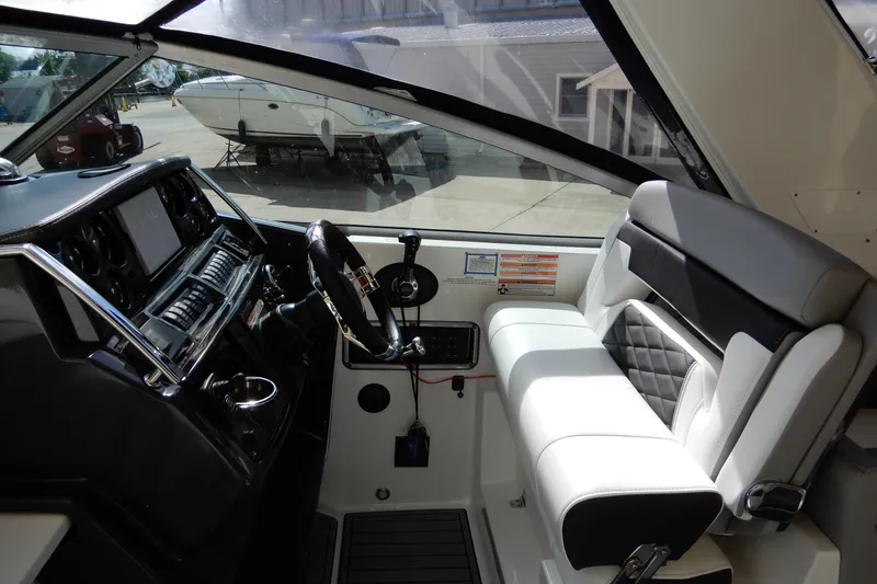 Slide: The Image of Interior of 2022 Monterey 295 Sport Yacht, featuring sleek helm and luxurious seating. - 21