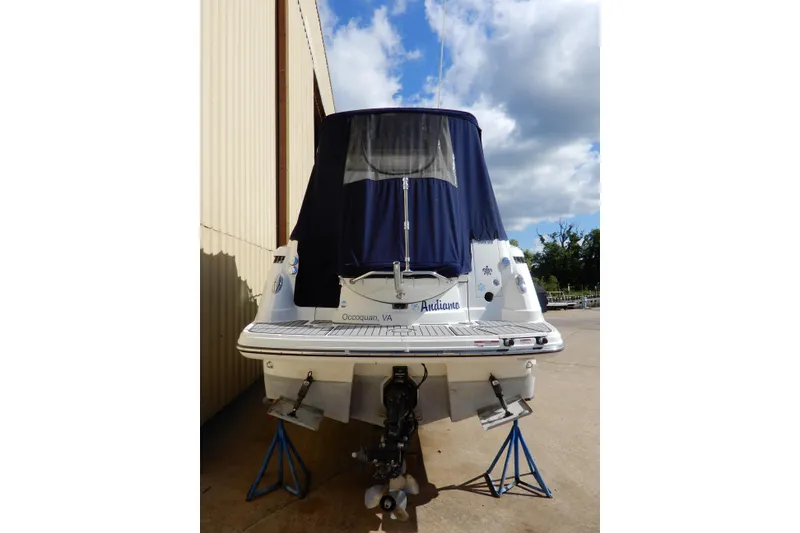 Slide: The Image of 2022 Monterey 295 Sport Yacht with blue cover, docked outdoors. - 3