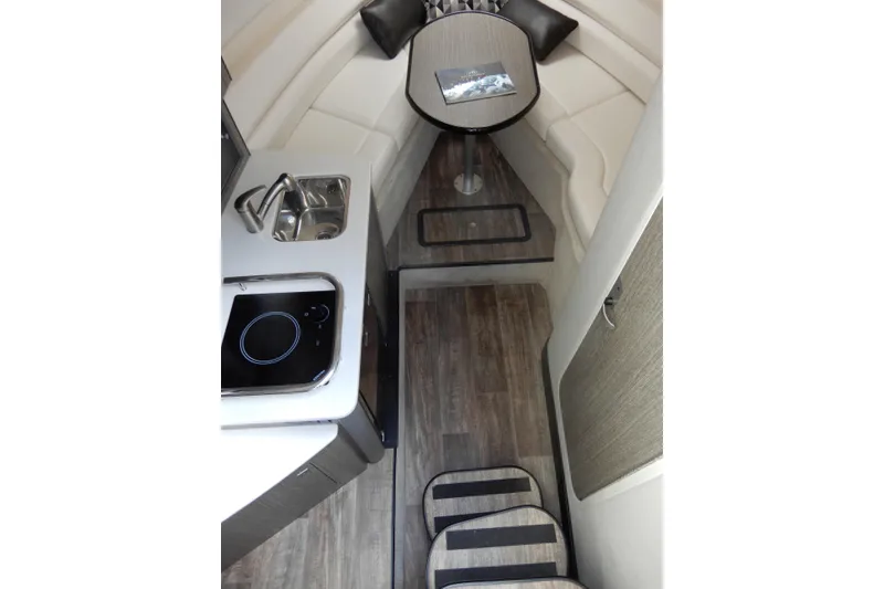Slide: The Image of Interior of 2022 Monterey 295 Sport Yacht with kitchenette and seating area. - 33