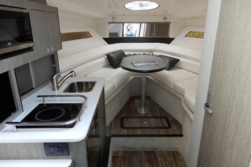 Slide: The Image of Luxurious interior of 2022 Monterey 295 Sport Yacht with kitchenette and seating area. - 34