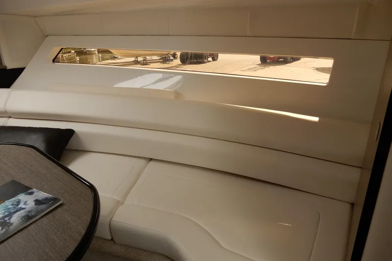 Slide: The Image of Interior of 2022 Monterey 295 Sport Yacht with sleek seating and window view. - 37