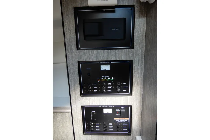 Slide: The Image of Control panels inside a 2022 Monterey 295 Sport Yacht, featuring various switches and displays. - 40