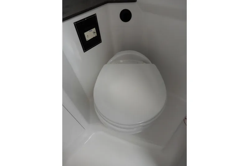 Slide: The Image of Toilet in 2022 Monterey 295 Sport Yacht bathroom, featuring sleek white design. - 48