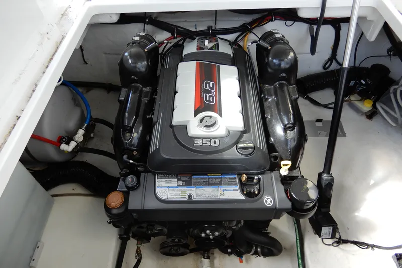 Slide: The Image of Engine compartment of 2022 Monterey 295 Sport Yacht, featuring a 6.2L 350 horsepower engine. - 49