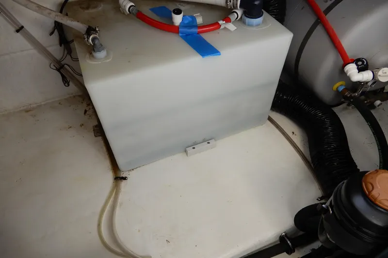 Slide: The Image of Engine compartment of 2022 Monterey 295 Sport Yacht with water tank and hoses. - 52