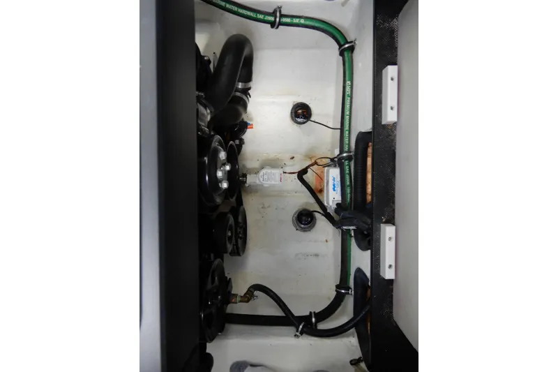 Slide: The Image of Engine compartment of 2022 Monterey 295 Sport Yacht with visible hoses and components. - 53