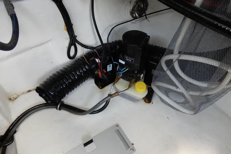 Slide: The Image of Engine compartment of 2022 Monterey 295 Sport Yacht with wiring and components. - 55