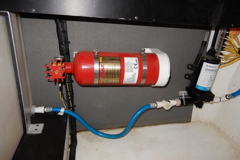 Slide: The Image of Engine compartment of 2022 Monterey 295 Sport Yacht with fire extinguisher and water pump system. - 57