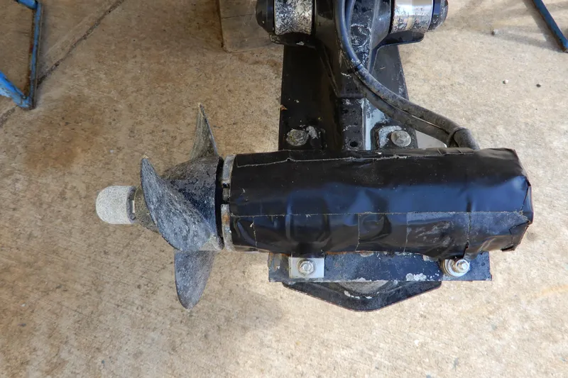 Slide: The Image of Propeller of a 2022 Monterey 295 Sport Yacht, wrapped in black tape, on concrete surface. - 61
