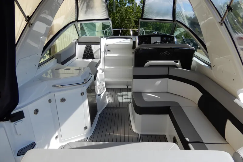 Slide: The Image of 2022 Monterey 295 Sport Yacht interior with sleek seating and modern design. - 9