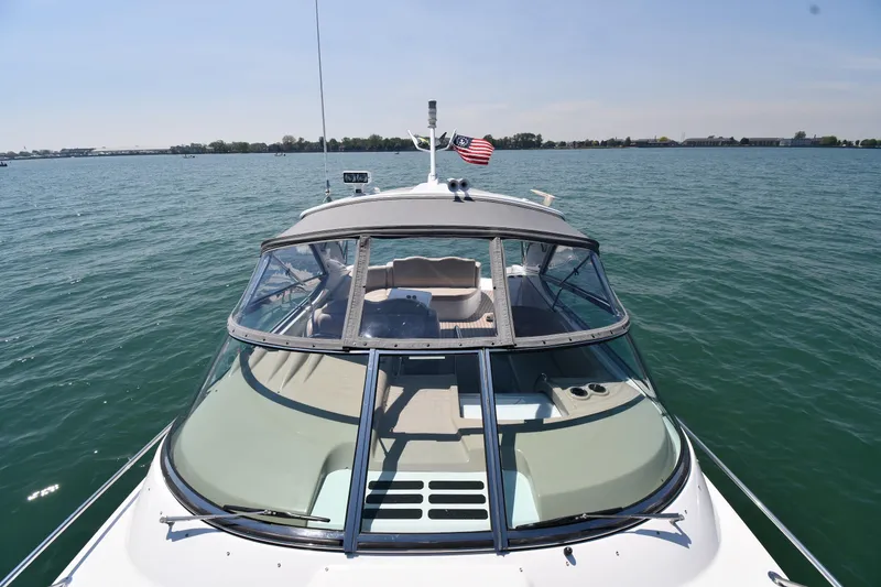 Slide: The Image of 2009 Formula 400 Super Sport boat cruising on a sunny lake with American flag. - 10