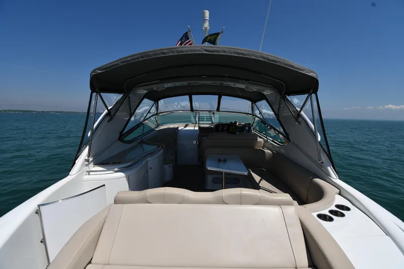 Slide: The Image of 2009 Formula 400 Super Sport boat interior with seating, table, and canopy on open water. - 11