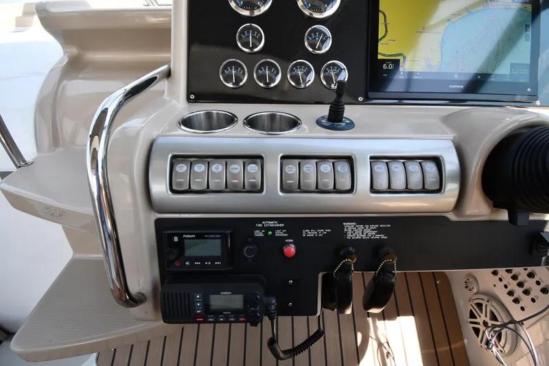 Slide: The Image of Dashboard of a 2009 Formula 400 Super Sport boat with controls and navigation display. - 16