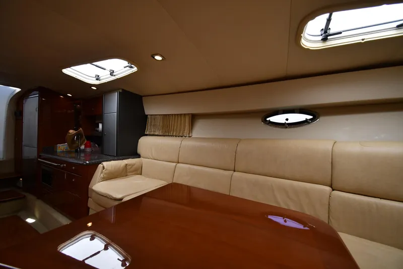 Slide: The Image of Luxurious interior of 2009 Formula 400 Super Sport yacht with beige seating and wooden table. - 32