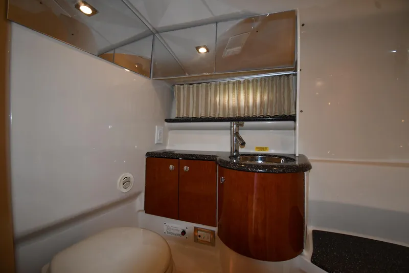 Slide: The Image of Luxurious bathroom interior of a 2009 Formula 400 Super Sport yacht, featuring wood cabinetry and modern fixtures. - 36