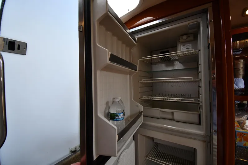 Slide: The Image of Open refrigerator inside 2009 Formula 400 Super Sport boat, showing shelves and a water bottle. - 41