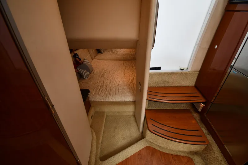 Slide: The Image of Interior cabin of a 2009 Formula 400 Super Sport boat with wooden steps and cozy bedding. - 42