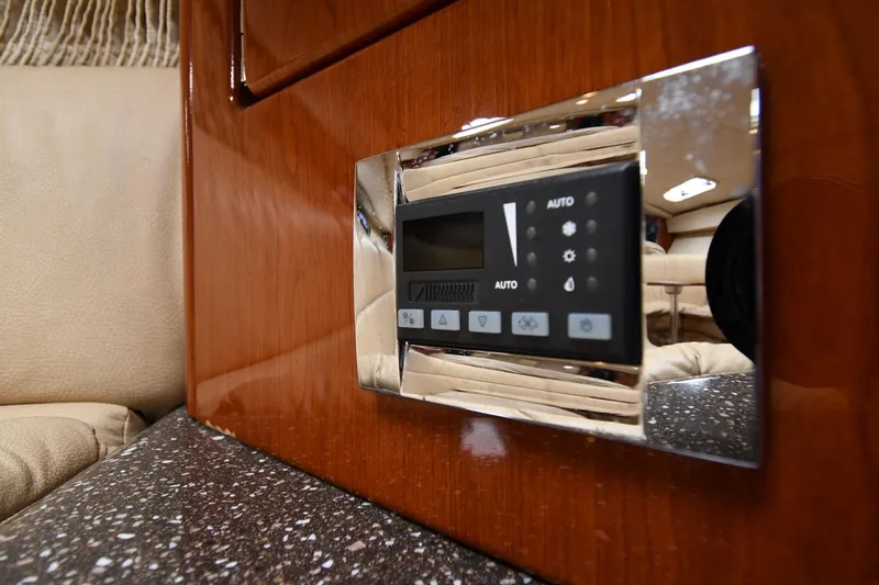 Slide: The Image of Control panel in 2009 Formula 400 Super Sport yacht interior, featuring wood and chrome accents. - 49