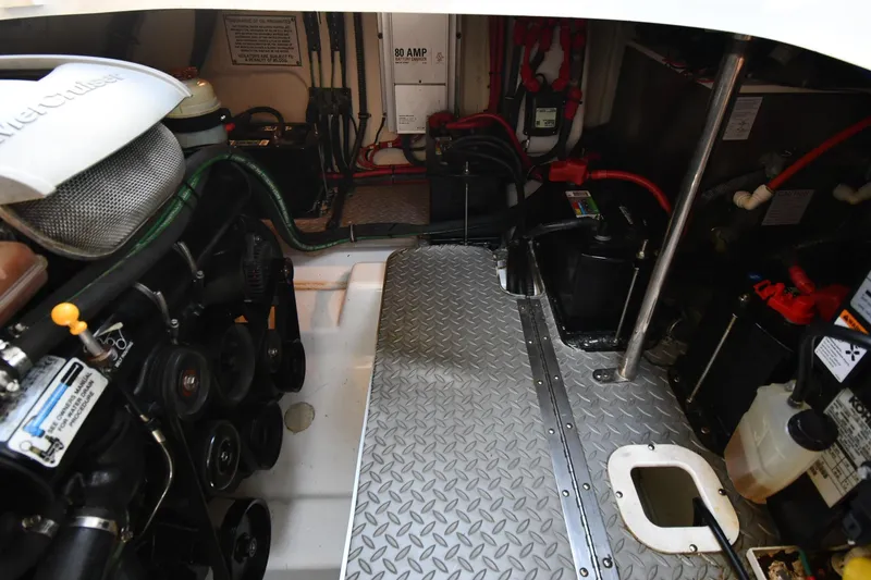 Slide: The Image of Engine room of a 2009 Formula 400 Super Sport boat, featuring mechanical components and wiring. - 53