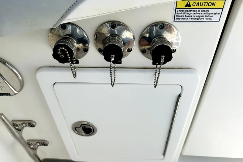 Slide: The Image of Boat engine flush fittings on a 2020 Regulator 34, with caution label visible. - 19