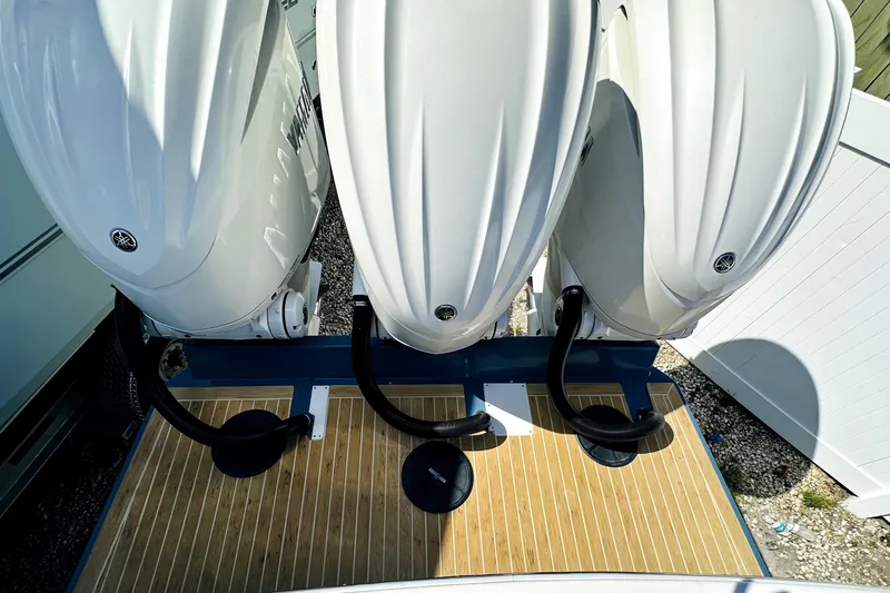 Slide: The Image of Triple outboard engines on a 2020 Regulator 34 boat, viewed from above. - 2