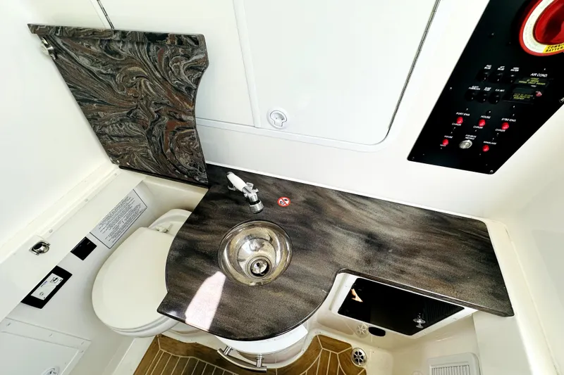 Slide: The Image of 2020 Regulator 34 boat bathroom with marble countertop and stainless steel sink. - 21