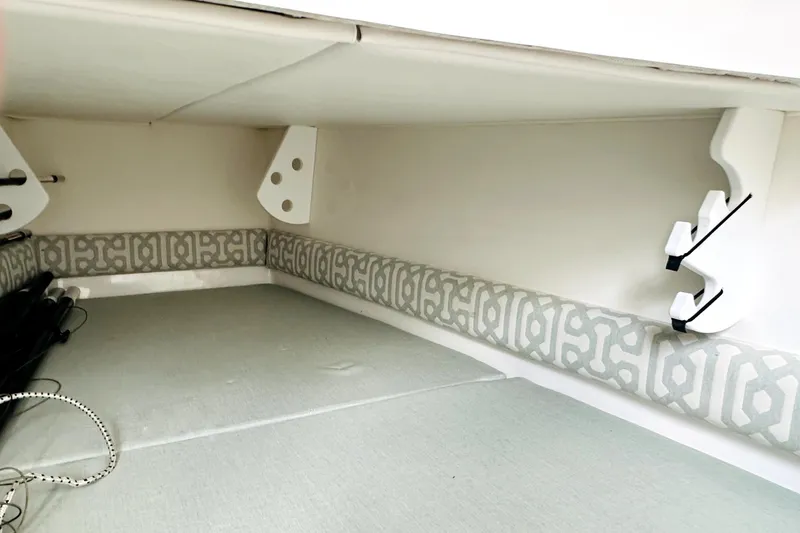 Slide: The Image of 2020 Regulator 34 boat interior with patterned cushions and storage space. - 23