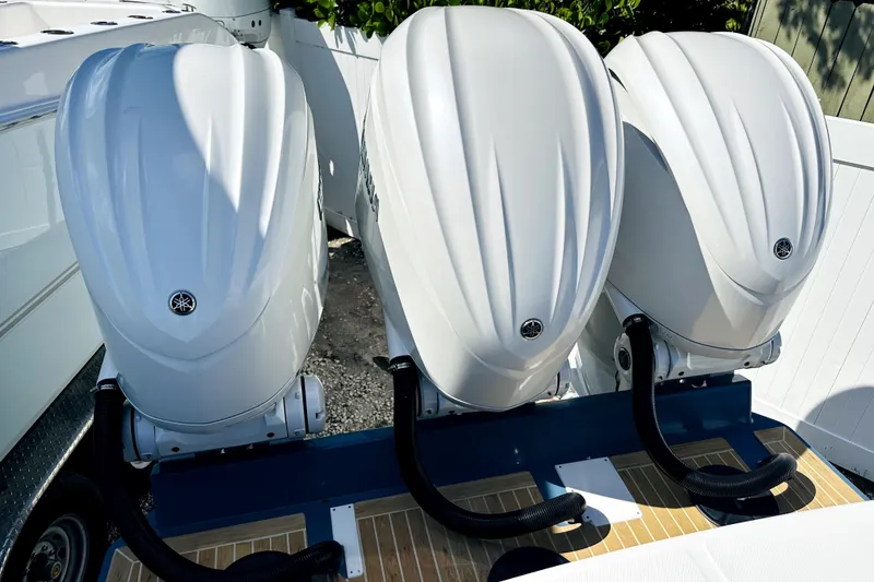 Slide: The Image of Triple Yamaha outboard engines on a 2020 Regulator 34 boat, docked outdoors. - 3