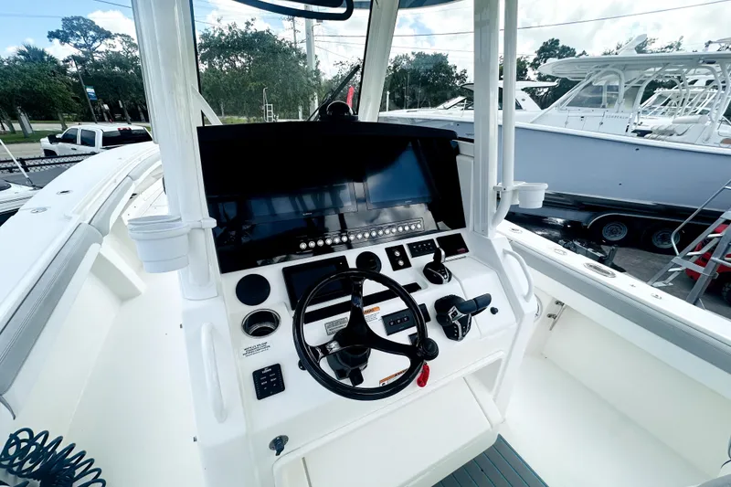 Slide: The Image of 2020 Regulator 34 boat cockpit with steering wheel and modern control panel. - 5