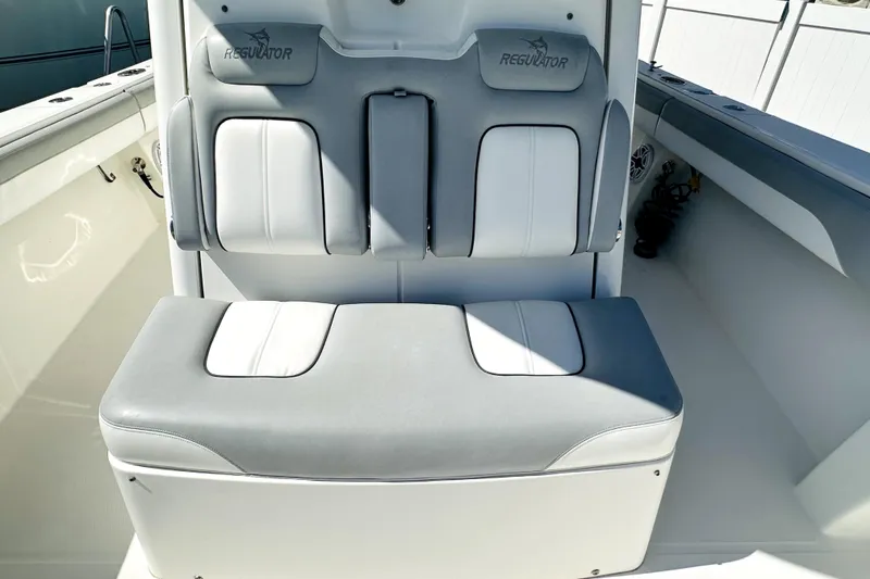 Slide: The Image of 2020 Regulator 34 boat seating with gray and white cushioned design. - 7