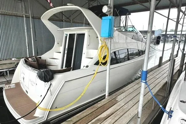 The Image of 2004 Carver 360 Mariner yacht docked in a covered marina slip. - 0