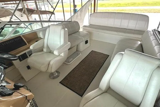 Slide: The Image of Interior of 2004 Carver 360 Mariner yacht with white leather seating and helm. - 10