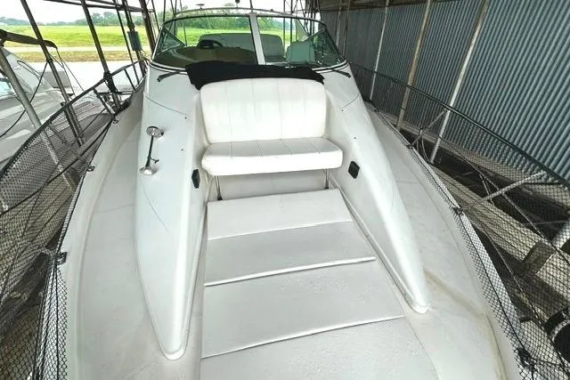 Slide: The Image of 2004 Carver 360 Mariner boat with white seating and spacious deck in a covered dock. - 11