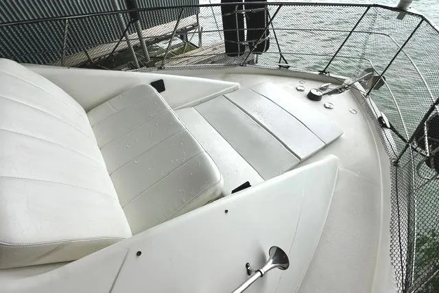 Slide: The Image of 2004 Carver 360 Mariner boat deck with white seating and metal railings. - 12