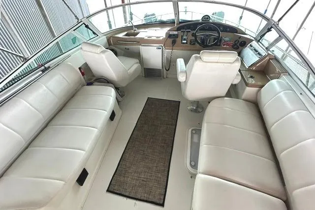 Slide: The Image of 2004 Carver 360 Mariner cockpit with white seating and helm controls. - 13