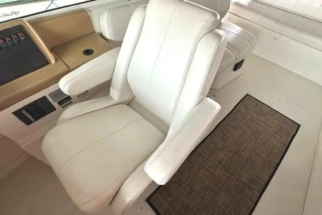 Slide: The Image of Captain's chair on 2004 Carver 360 Mariner yacht, featuring white upholstery and control panel. - 14
