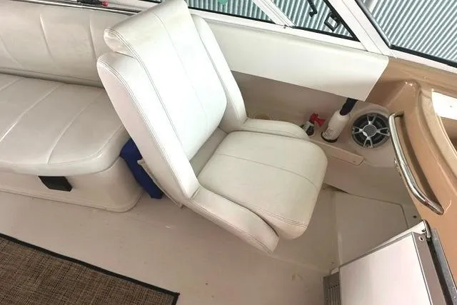 Slide: The Image of Interior of 2004 Carver 360 Mariner boat with white seating and speaker. - 15