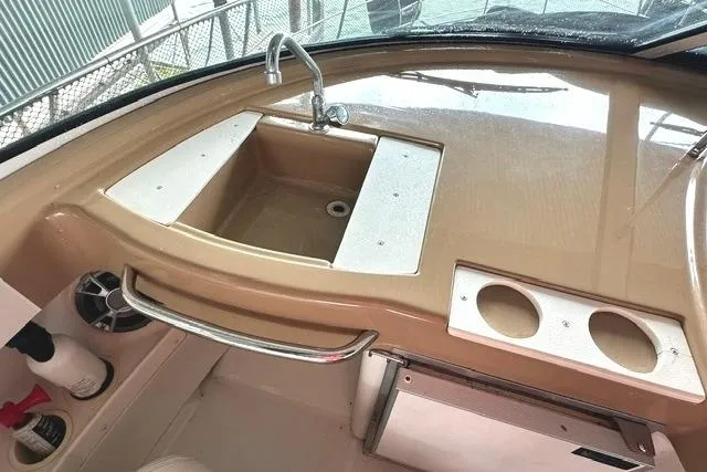 Slide: The Image of 2004 Carver 360 Mariner boat sink and countertop with cup holders. - 16