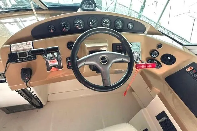 Slide: The Image of 2004 Carver 360 Mariner helm with steering wheel and control panel. - 17