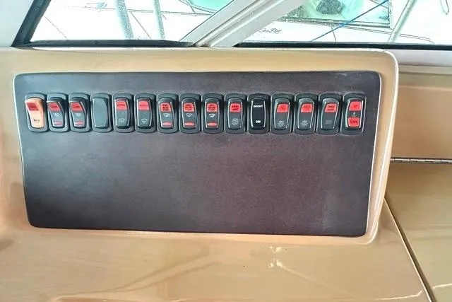 Slide: The Image of Control panel of a 2004 Carver 360 Mariner boat with multiple switches. - 18
