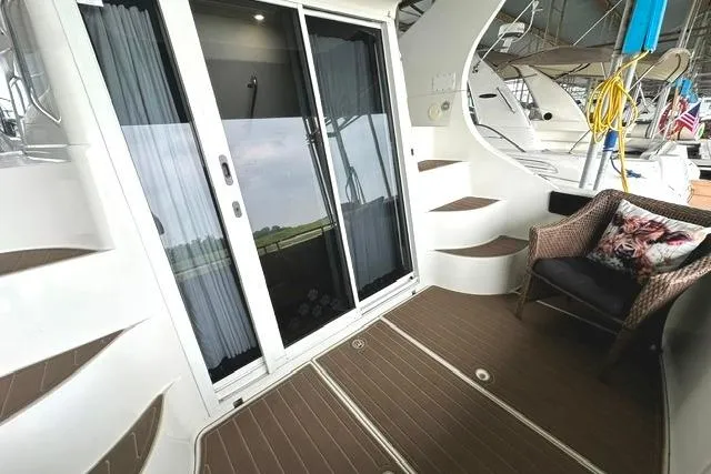 Slide: The Image of 2004 Carver 360 Mariner yacht interior with sliding glass doors and seating area. - 21