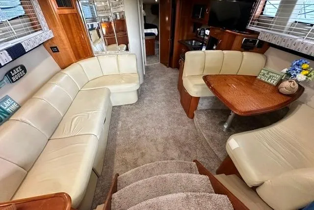 Slide: The Image of Luxurious interior of 2004 Carver 360 Mariner yacht with plush seating and elegant wood finishes. - 22