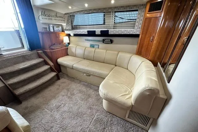 Slide: The Image of Interior of 2004 Carver 360 Mariner with beige leather seating and cozy decor. - 24